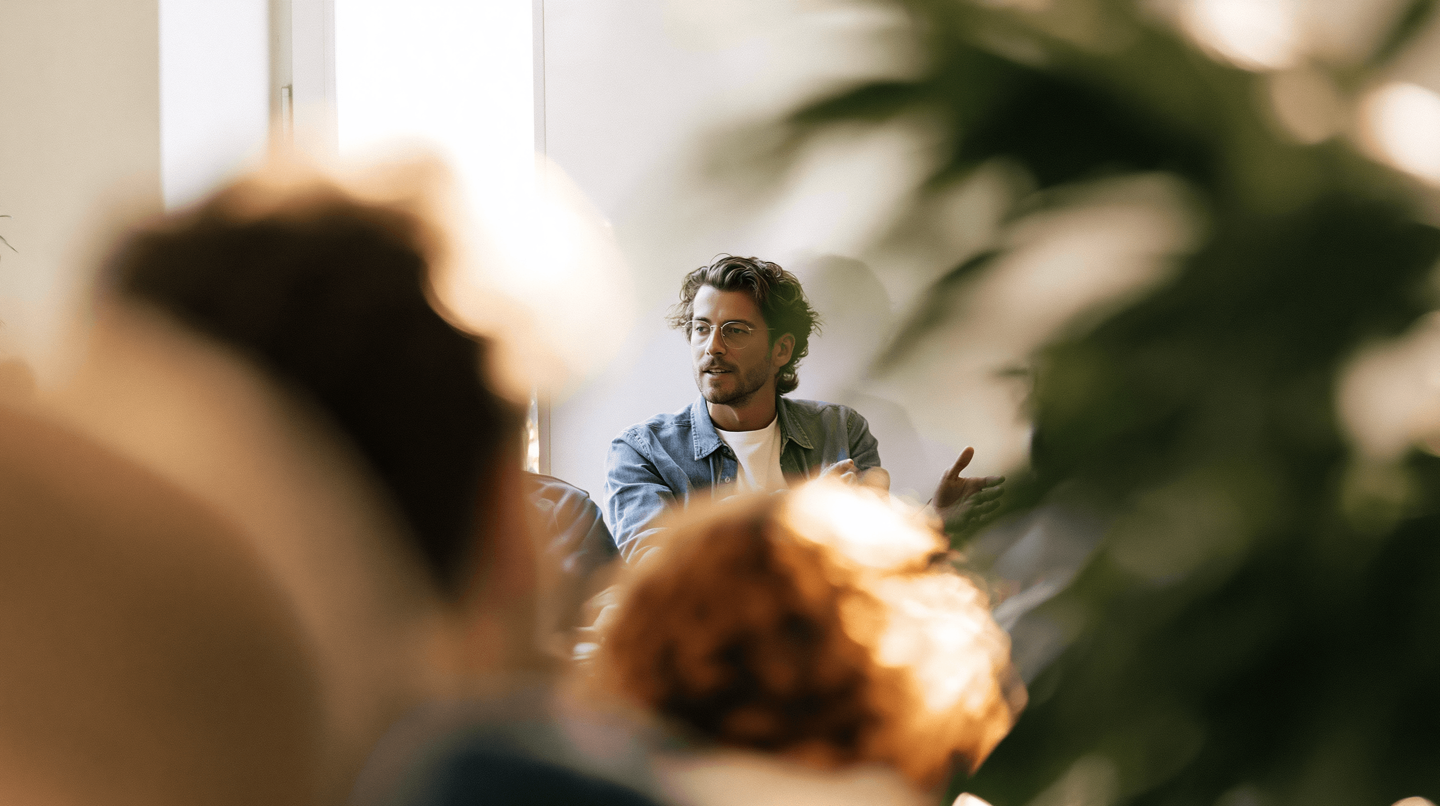 A founder mid-conversation in a room of people, making the argument in person